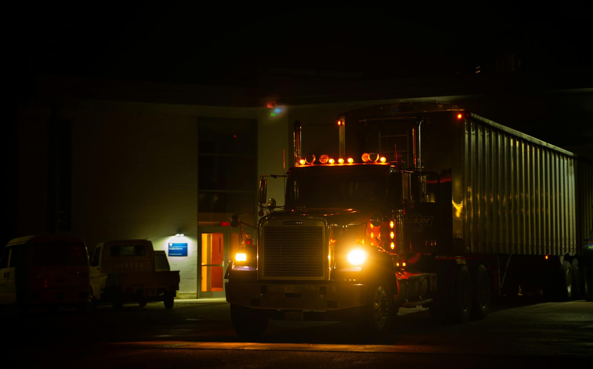 Freight truck at a loading dock at night